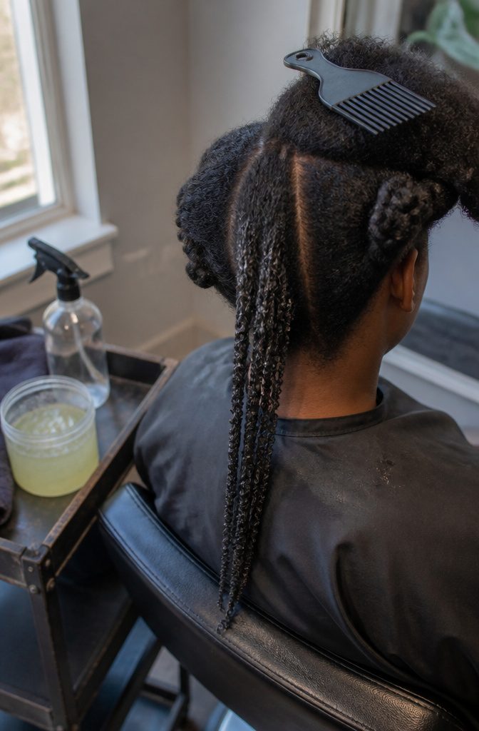 Wet 4C hair separated into narrow shingled clumps with coiled ends