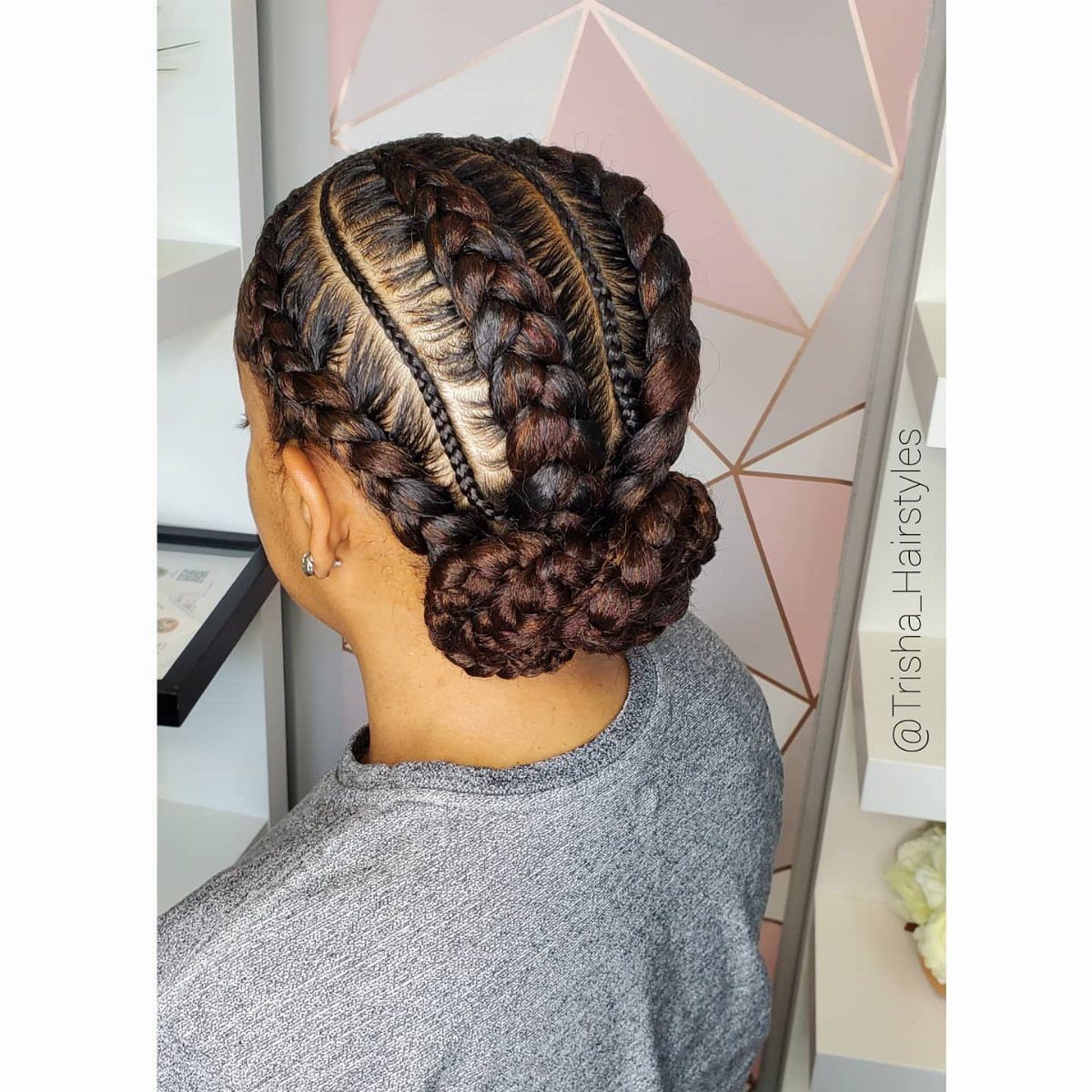 Dark cornrow braids gathered into a full bun at the nape