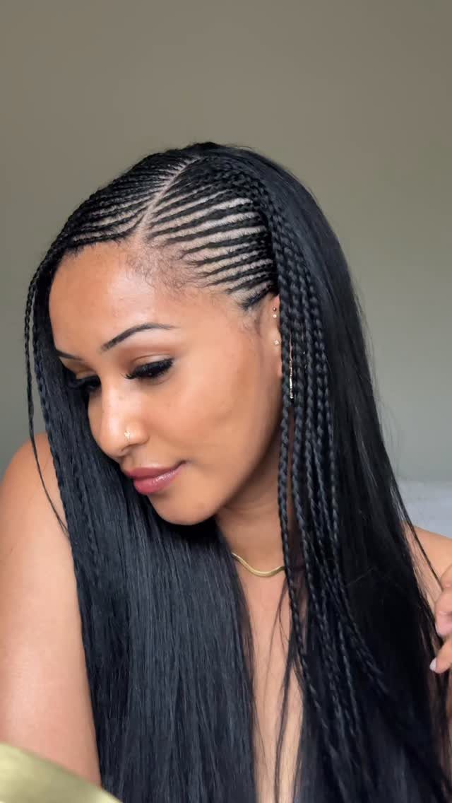 Woman showing curved cornrows blending into long black braids