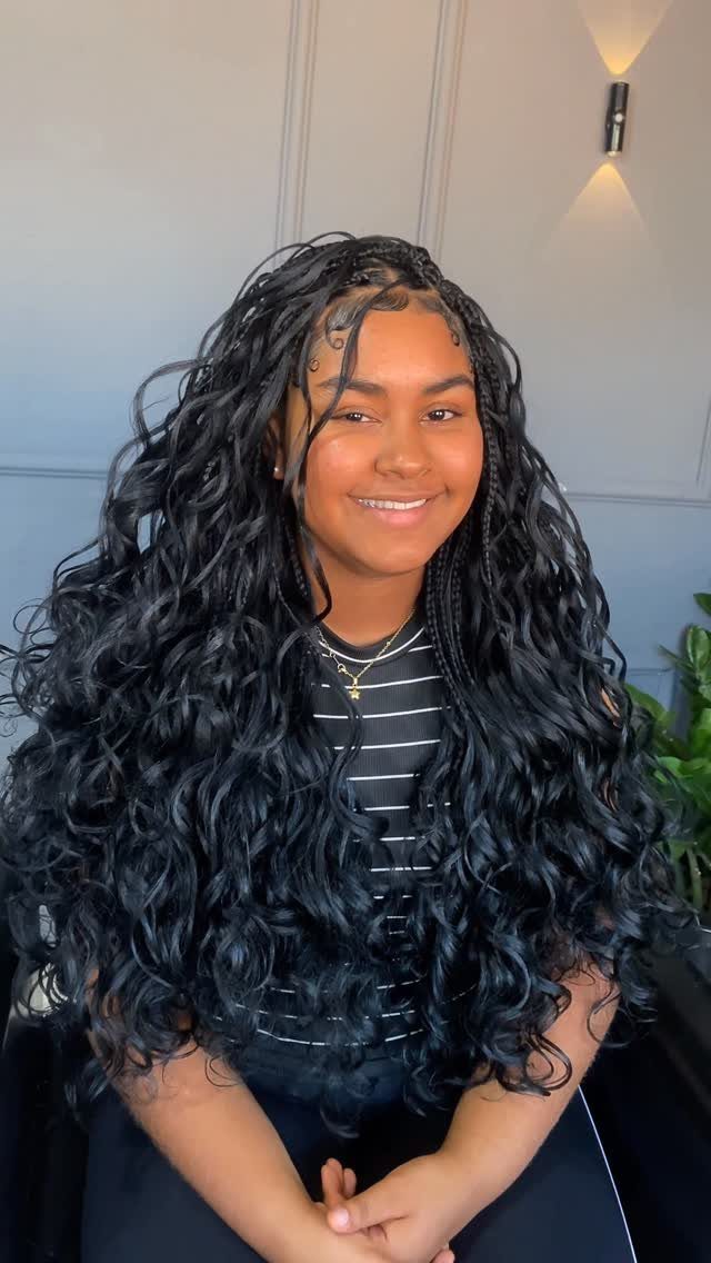 Woman with long black braids transitioning into loose, defined curls