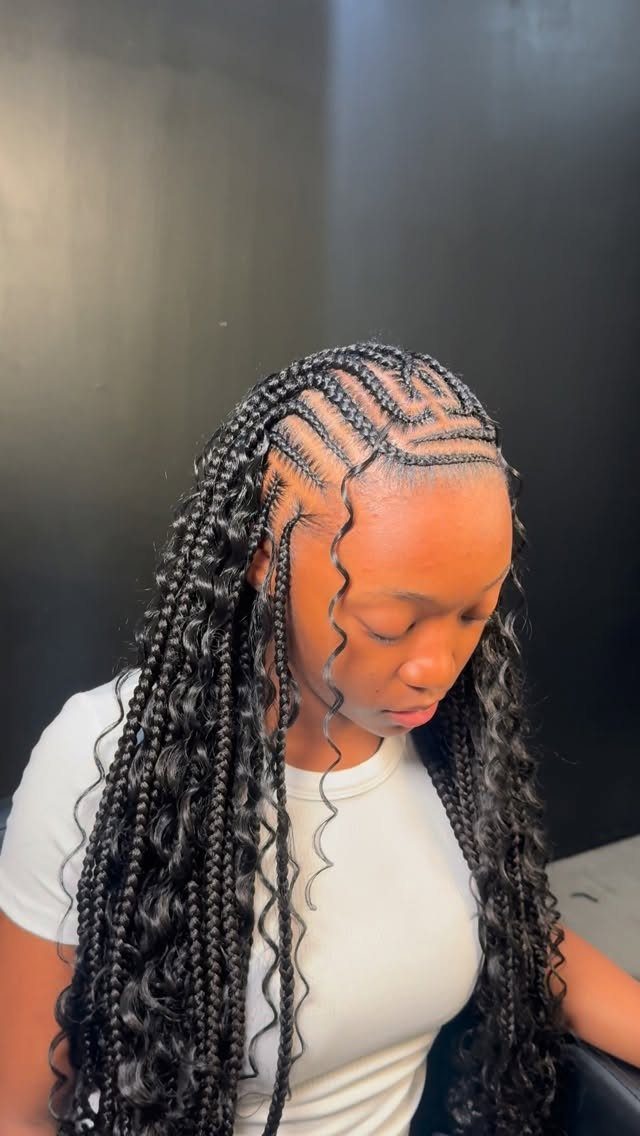 Woman wearing long black synthetic boho braids with loose curly strands
