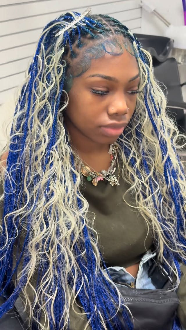 Woman wearing long vivid blue braids mixed with pale blonde waves
