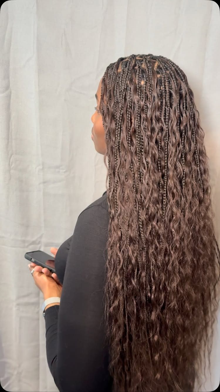 Long brown braids with flowing water-wave curls shown from the side