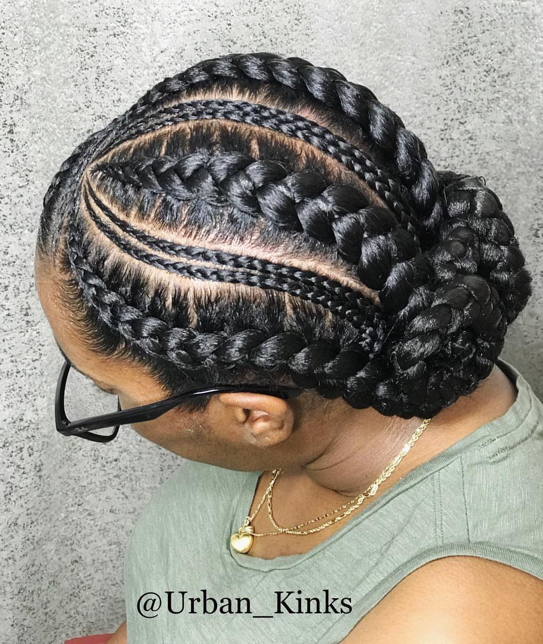 Woman wearing an elaborate woven braided bun with multiple cornrow-style braids