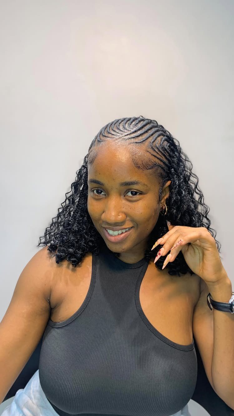 Woman showing cornrows flowing into long braids with loose curls