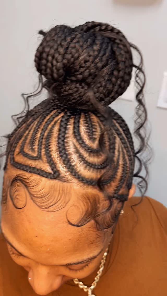 Braided bun with curved cornrows and loose side curls