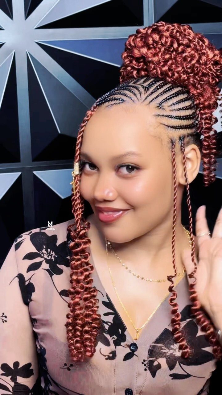 Woman displaying curved cornrows gathered into a high reddish-brown curly bun