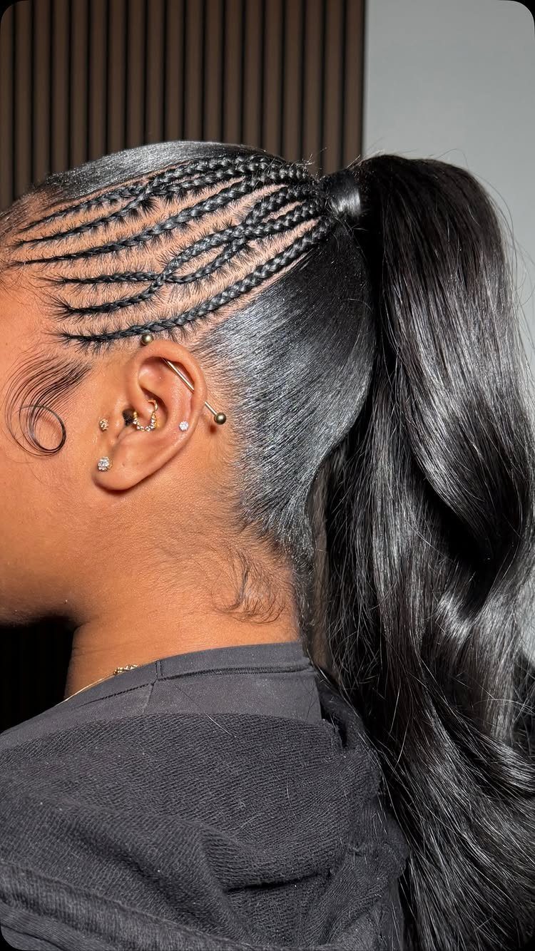 Sleek cornrow braids gathered into a glossy high ponytail