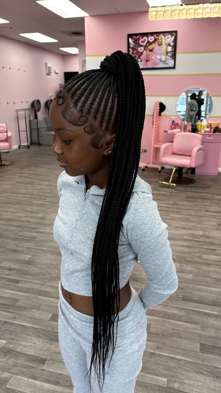 Stitch-pattern cornrows gathered into a high ponytail of long black braids