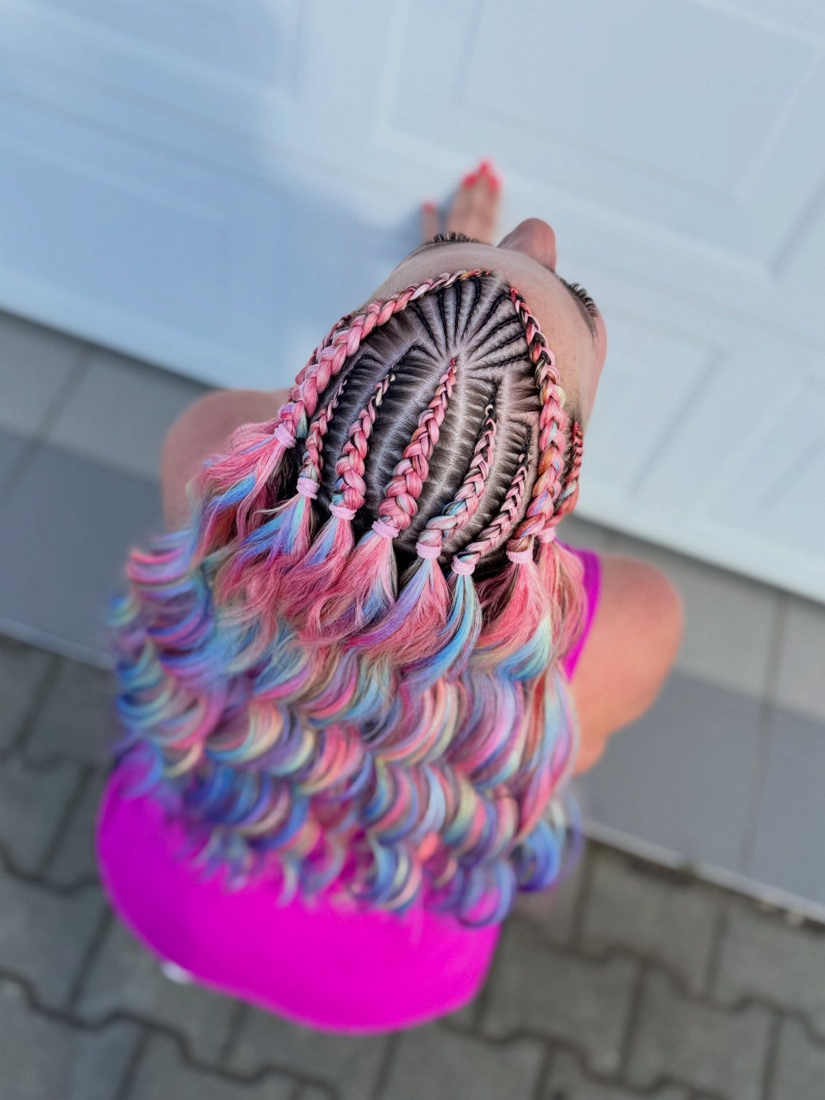 Short colorful half-up braids with loose pink, blue, and lavender curls