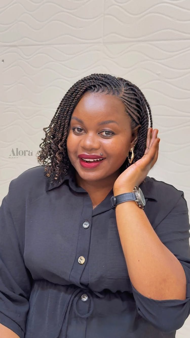 Woman with cornrowed sections and shoulder-length twists posing