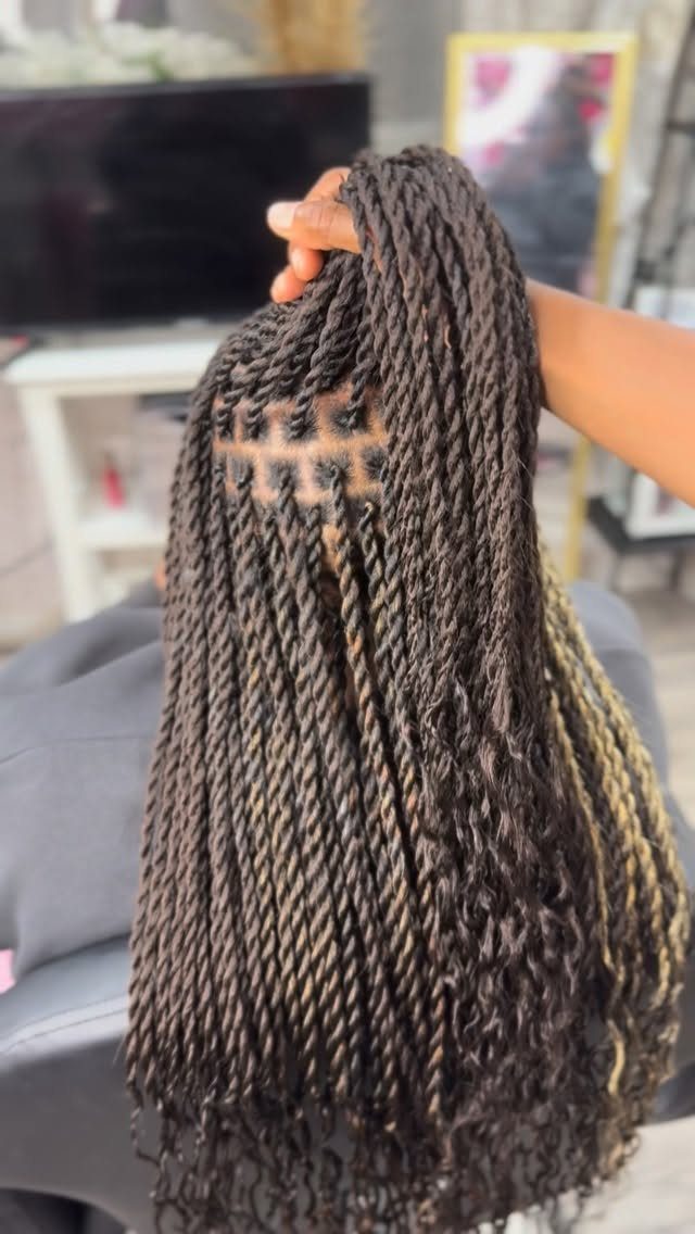 Long chunky dark twists lifted to reveal neat square scalp parts