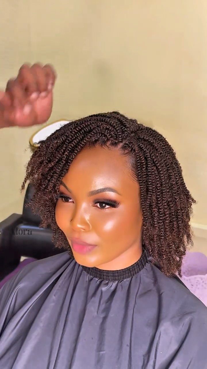 Woman wearing medium-length dark crochet passion twists in a salon