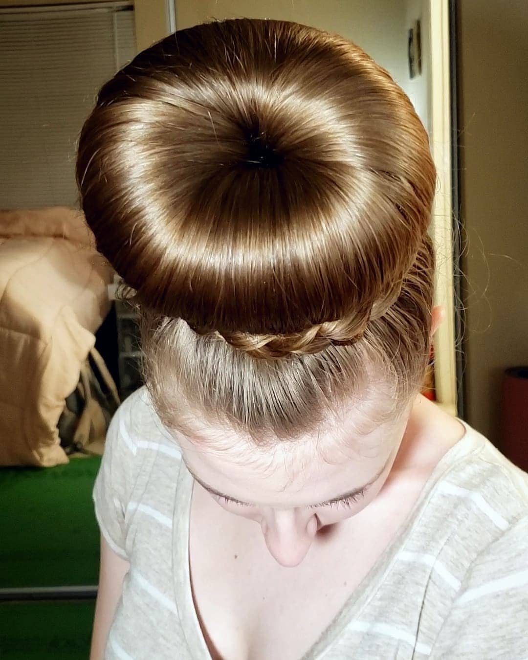 Smooth brown hair roll with a small braid wrapped around its lower edge