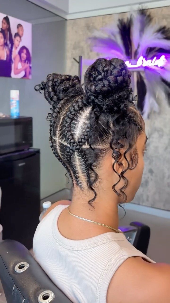 Braided double buns with scalp braids and loose curls in a salon chair