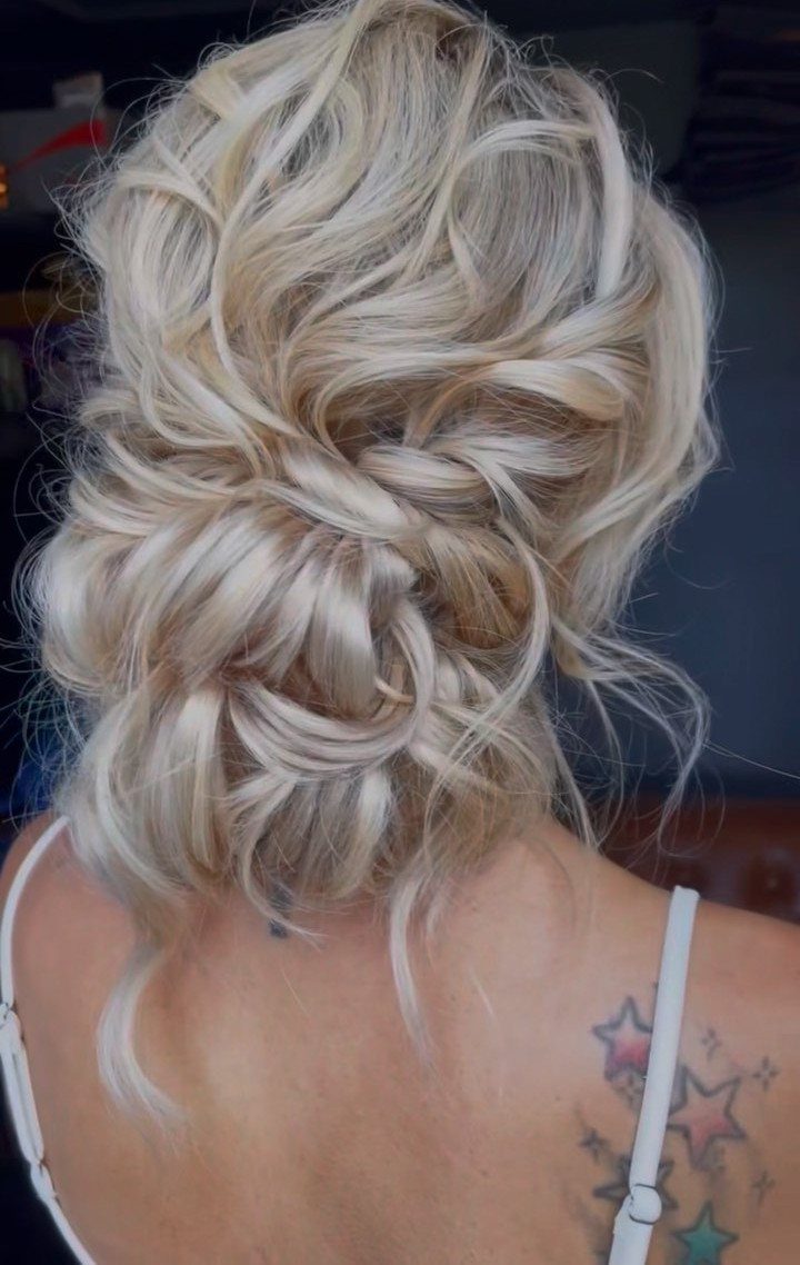 Blonde messy bun with overlapping twists and loose textured loops