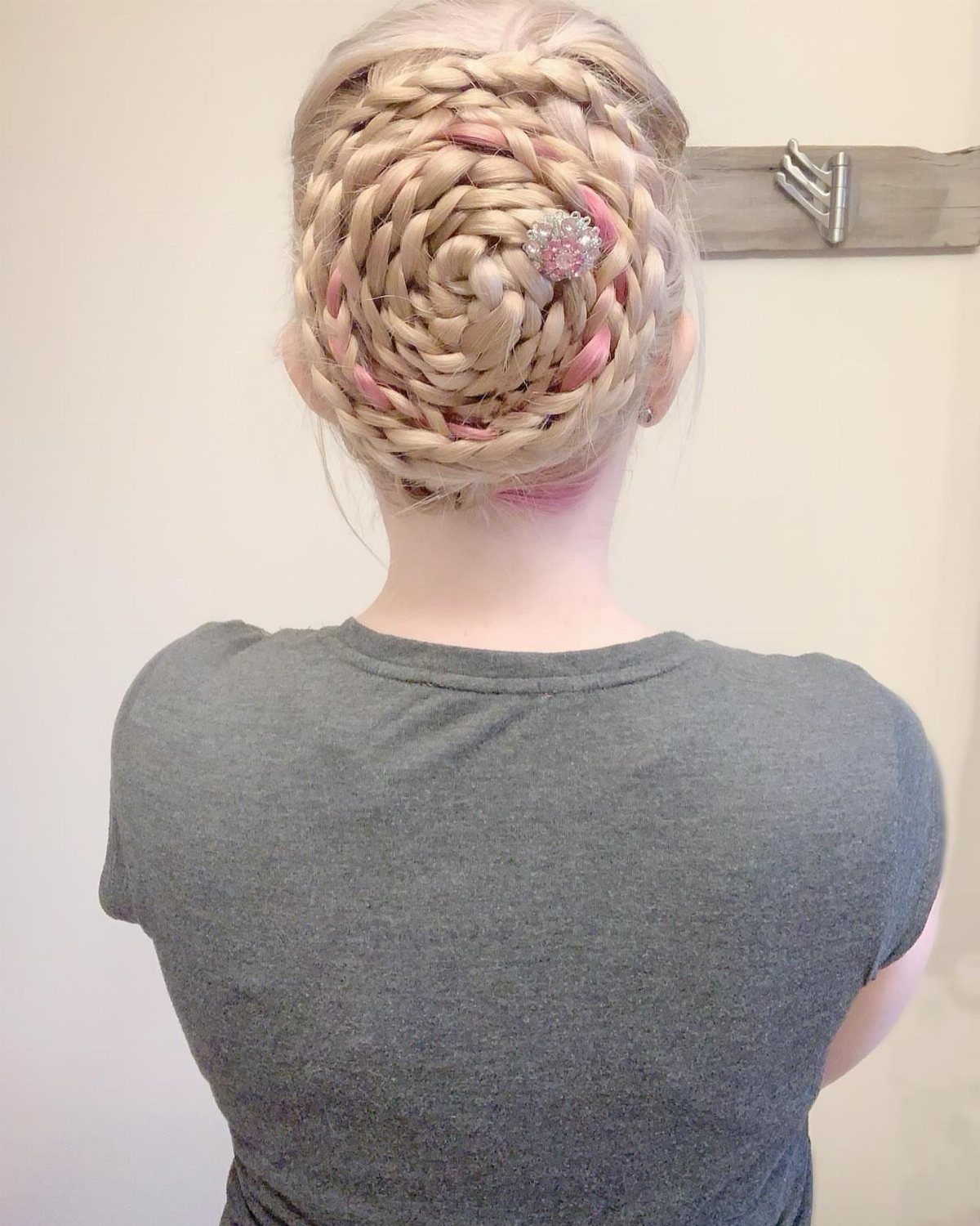 Blonde and pink hair arranged in a large braided vertical roll
