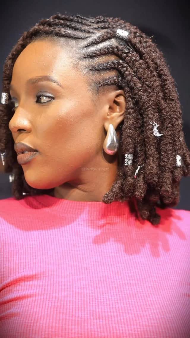 Woman displaying dark crochet twists with scalp braids and silver cuffs
