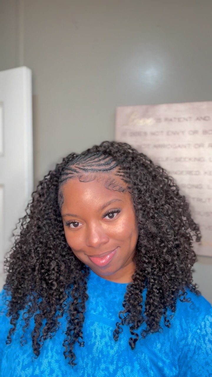 Woman displaying long dark crochet braids with loose curly ends
