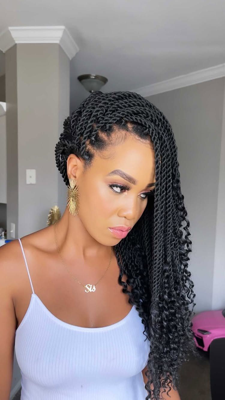 Woman modeling long black Senegalese twists swept over one shoulder