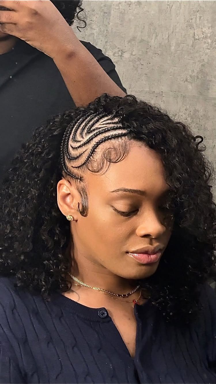 Woman with curly crochet hair and curved cornrows framing her hairline