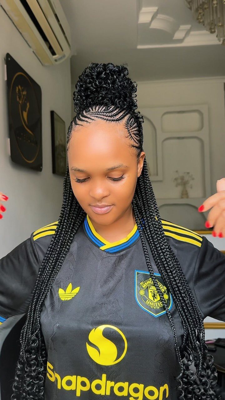 Woman wearing long black crochet braids gathered into a high bun