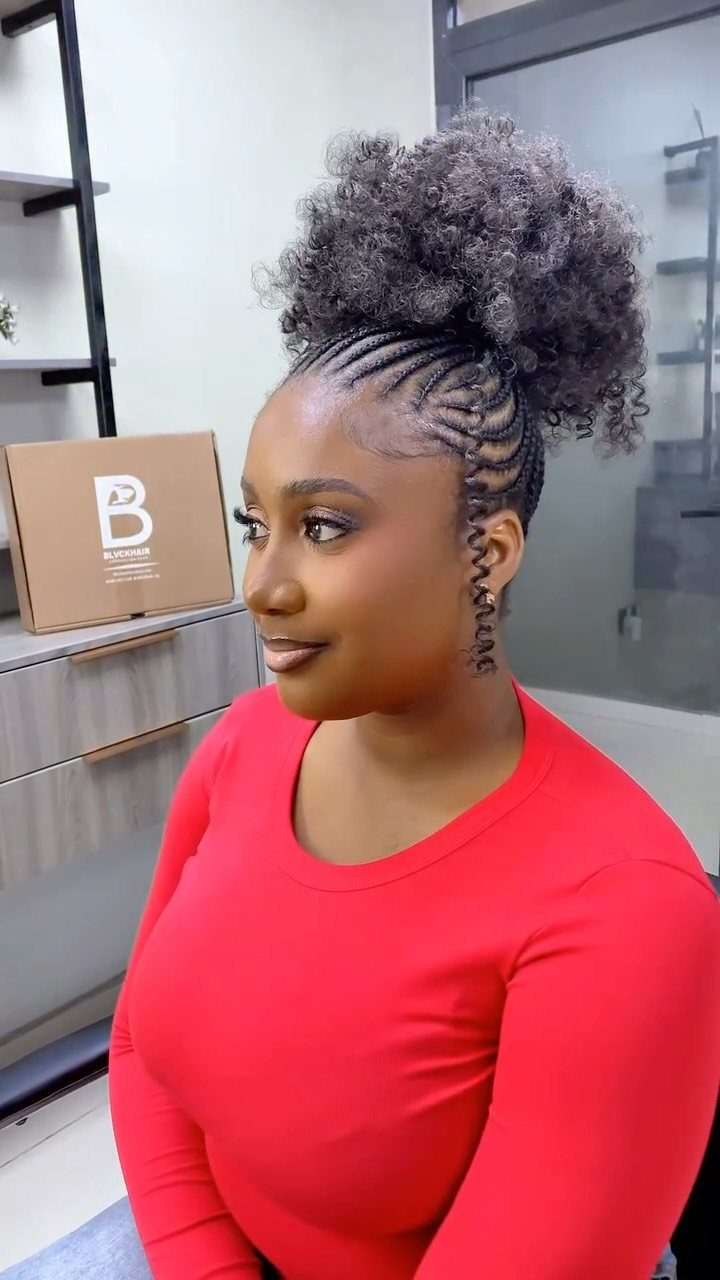 Woman with cornrows and a voluminous curly crochet ponytail