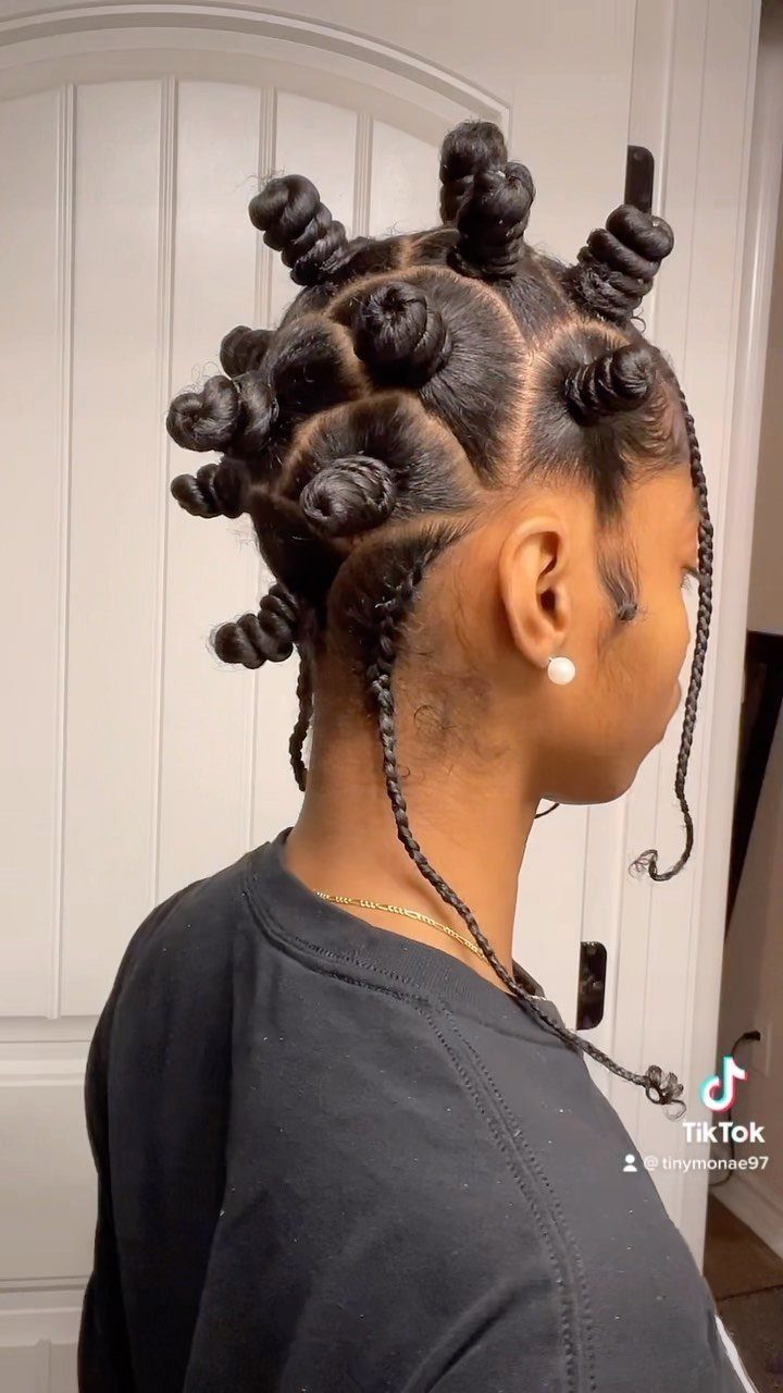 Bantu knot braids arranged across a person's head with thin braids hanging down