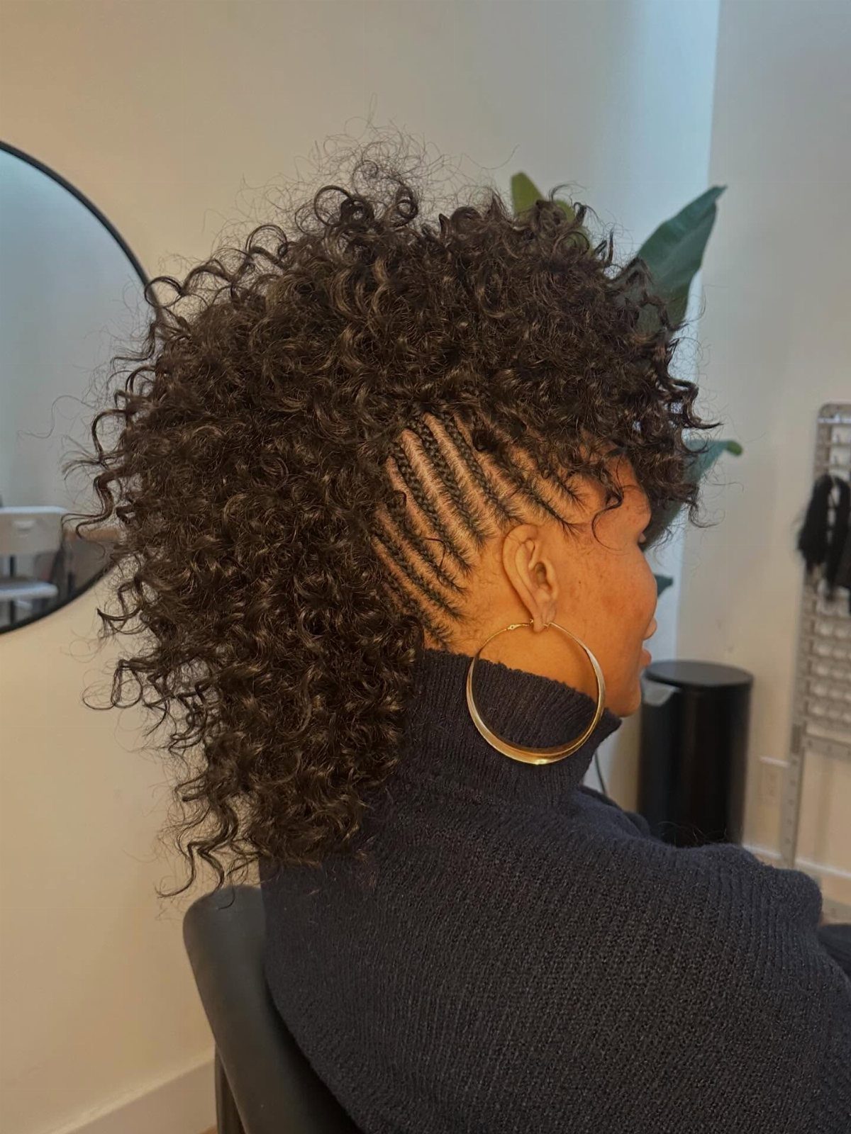 Curly braided mohawk with temple cornrows and voluminous curls