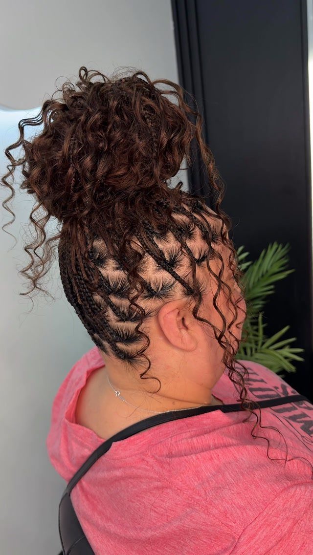 High braided bun with loose curls and patterned scalp braids