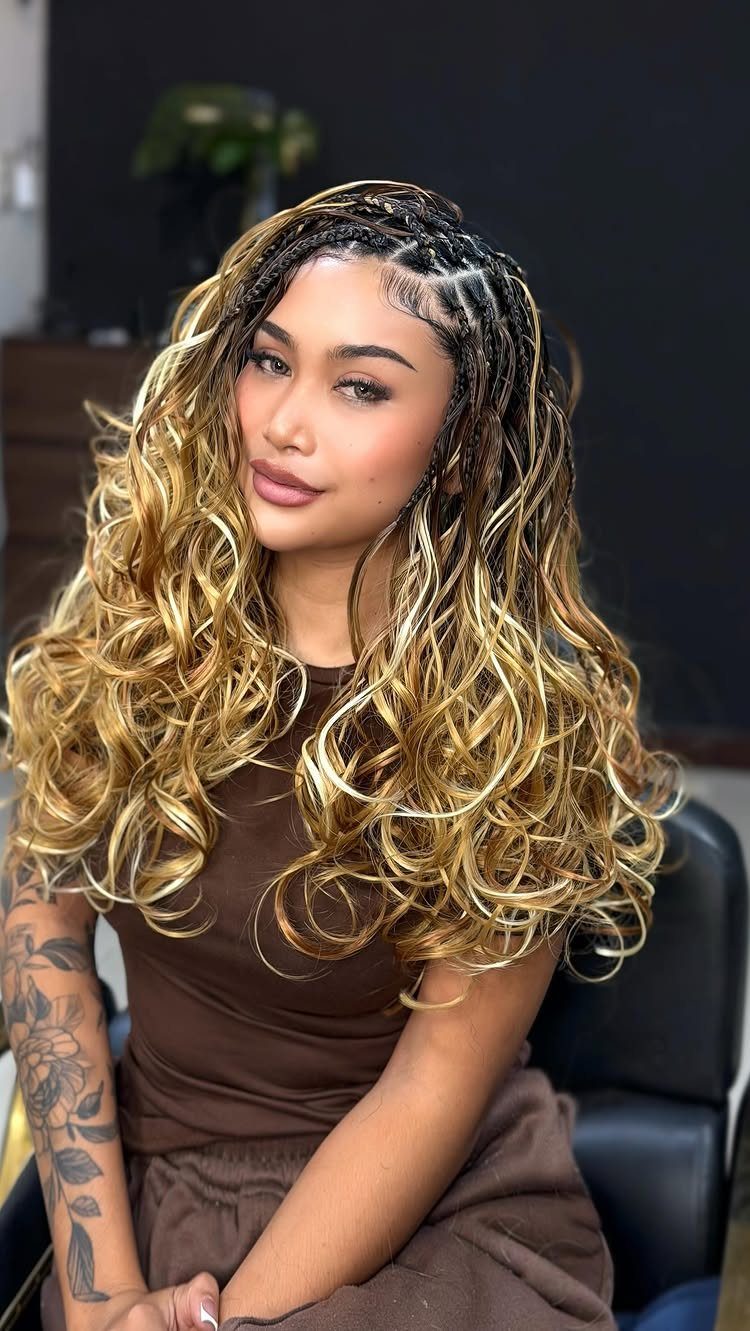 Woman with long curly blonde hair and small side cornrow braids