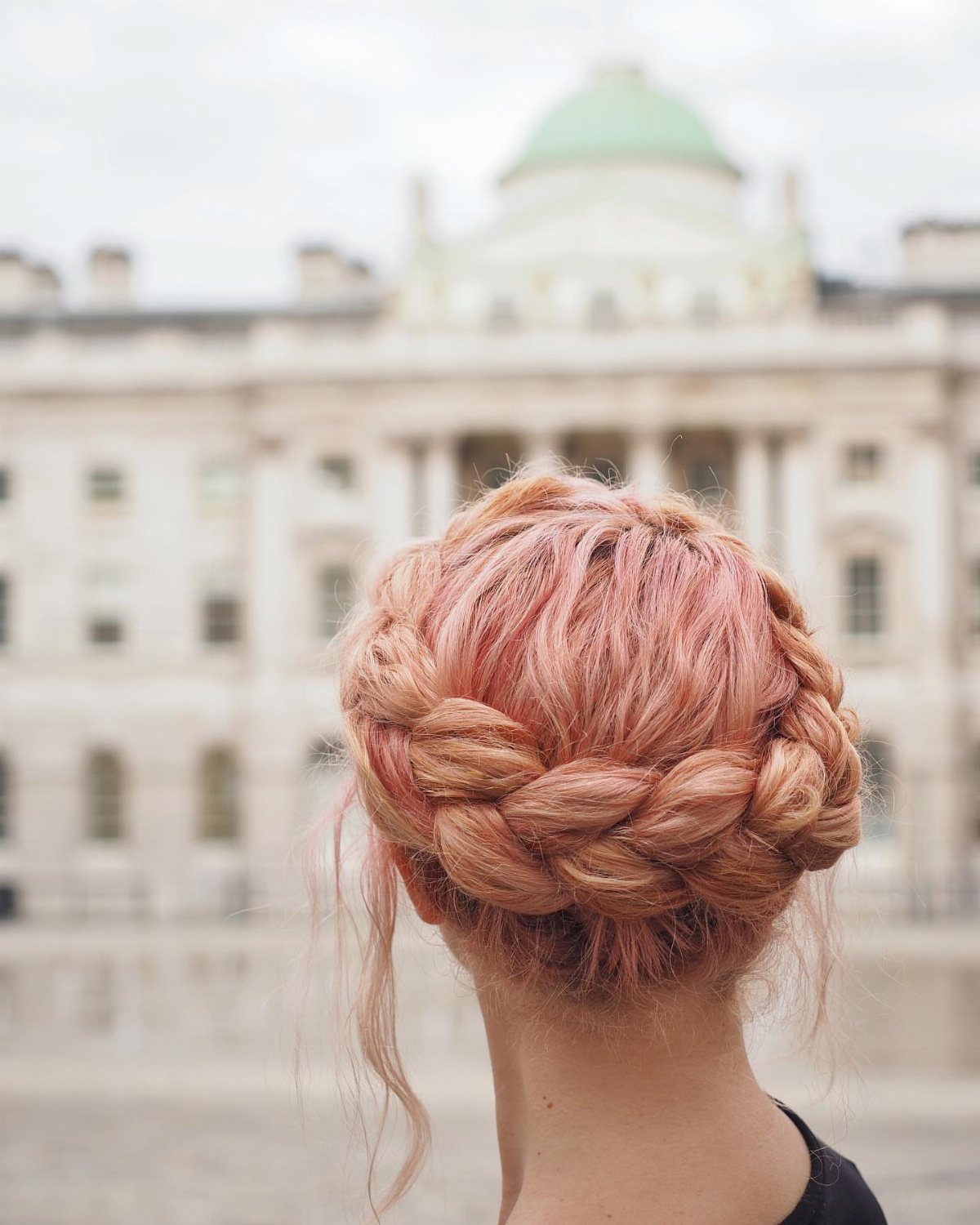 Rose-pink hair arranged in a thick crown braid around the head