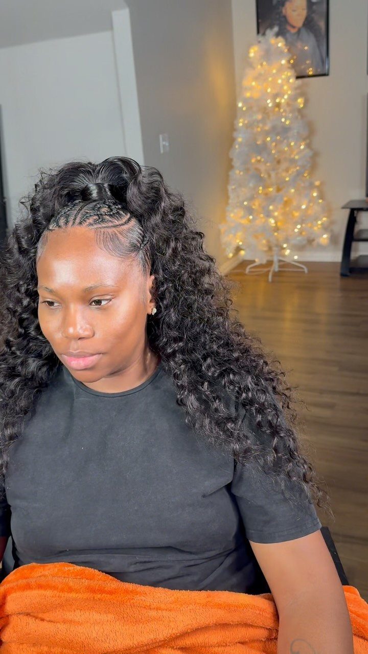 Woman with braided front section and long curls left loose around her shoulders