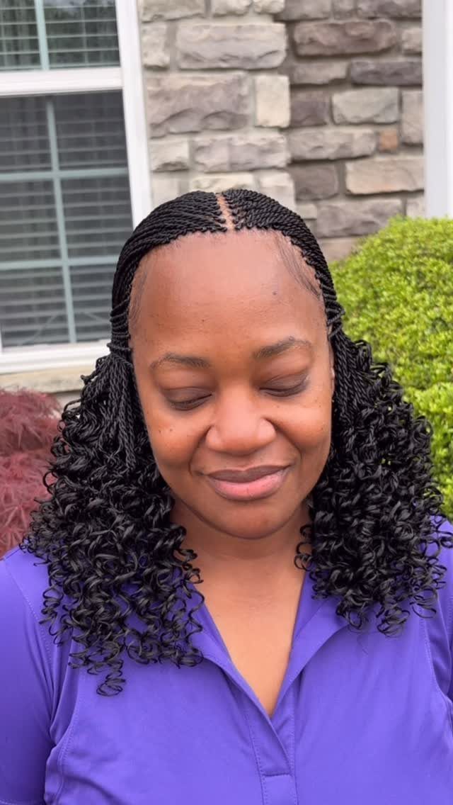 Woman wears fine scalp braids with dense shoulder-length curls