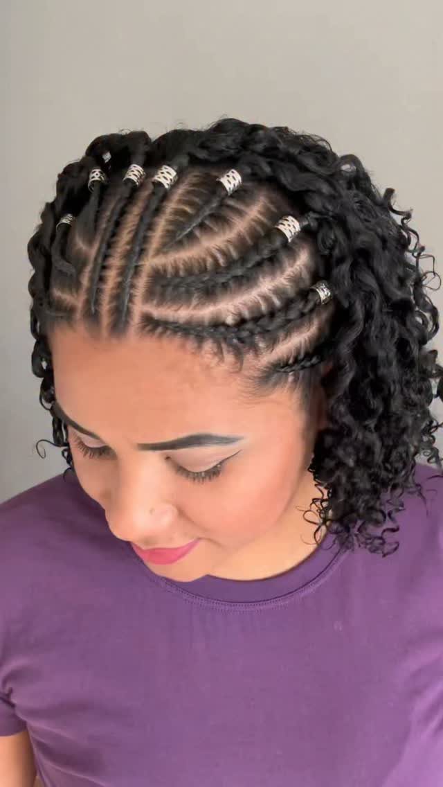 Patterned crown cornrows with silver cuffs transition into loose dark curls