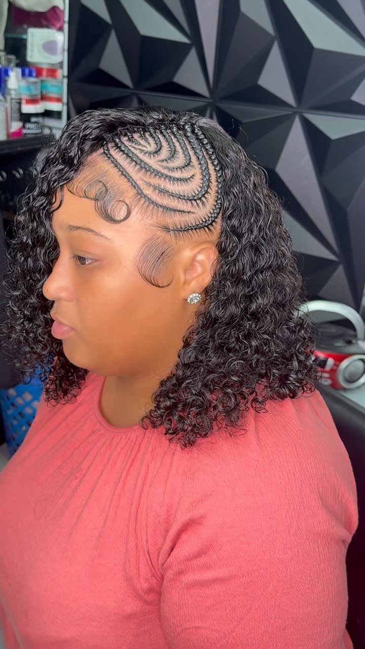 Woman with side cornrows pinning back loose shoulder-length curls
