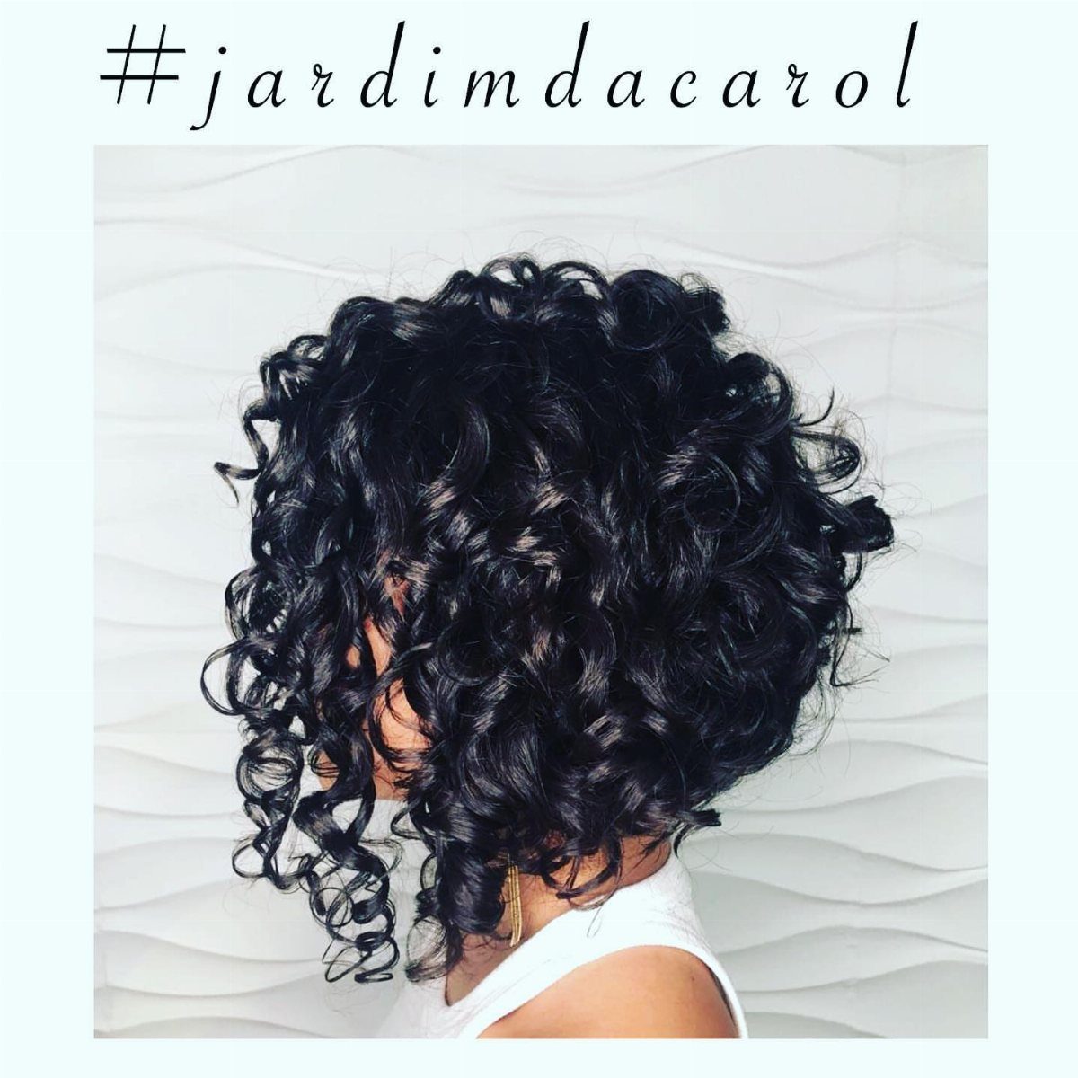 Asymmetrical curly bob with longer black curls framing the face