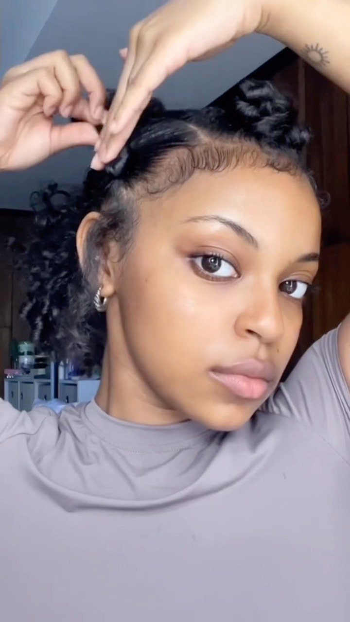 Woman twists a section of hair beside several small knots on her crown