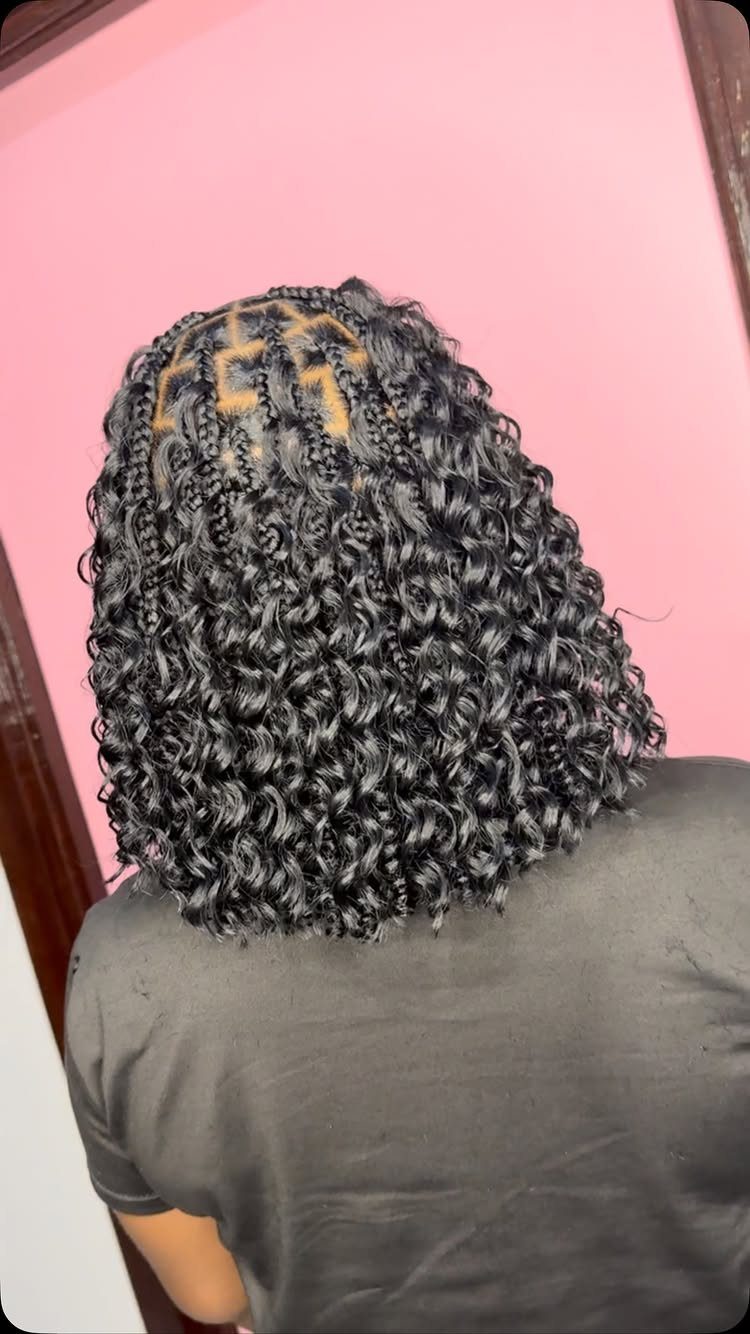 Shoulder-length curly bob with geometric braids at the crown