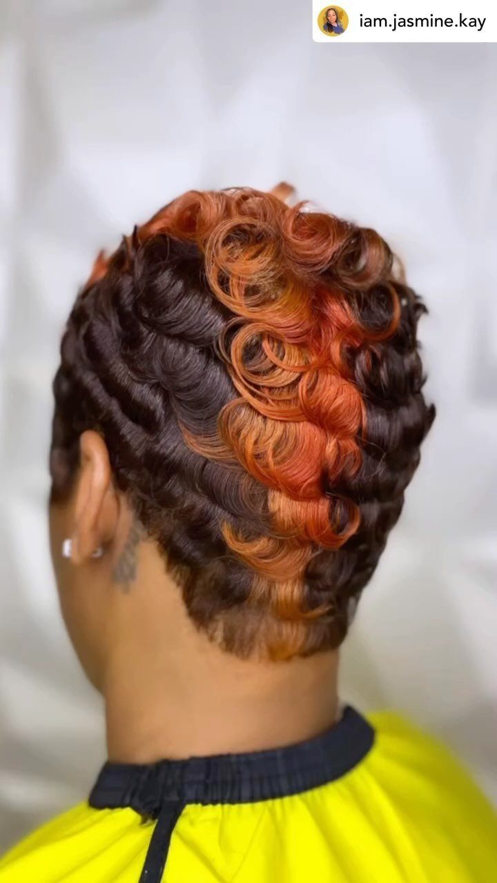 Short curly pixie cut with copper-orange curls and a tapered nape
