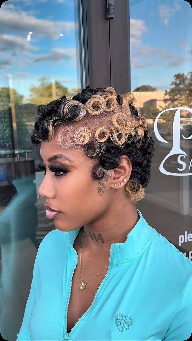 Woman showing a short curly pixie cut with dark and blonde curls