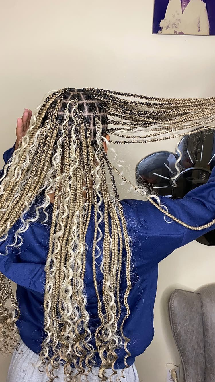 Long boho goddess braids with curly blonde and white strands viewed from behind