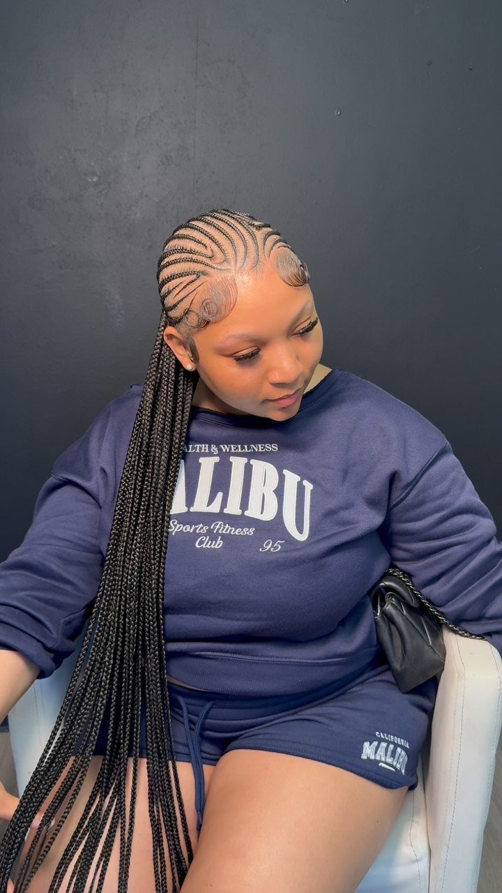 Person displaying long curved cornrows extending into thin braids