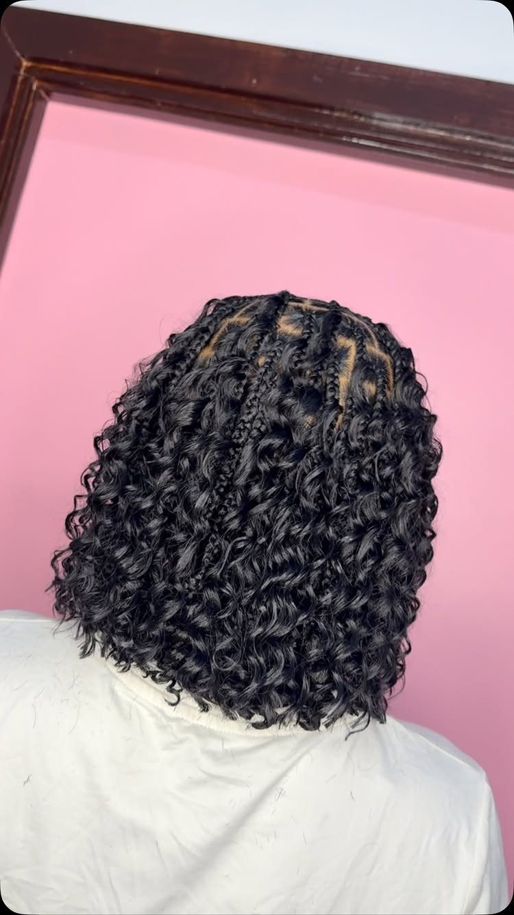 Short curly goddess braids form a bob at the back of the head