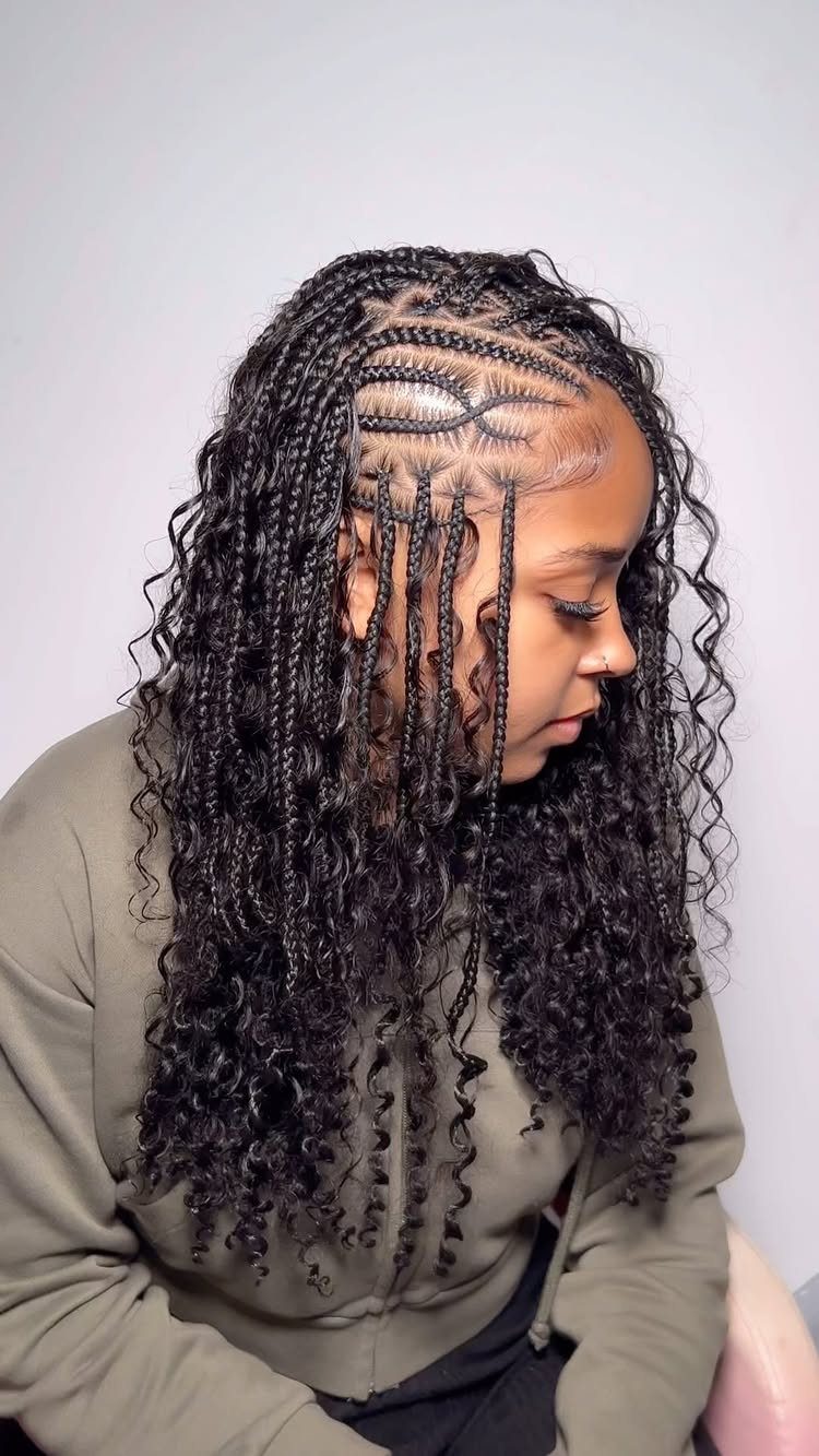 Profiled person showing side-swept cornrow braids with long curly lengths