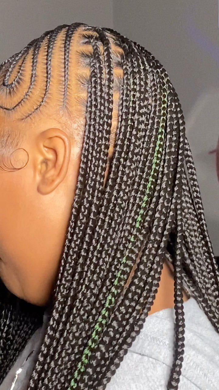 Small flowing cornrows curve across the scalp and continue into long braids