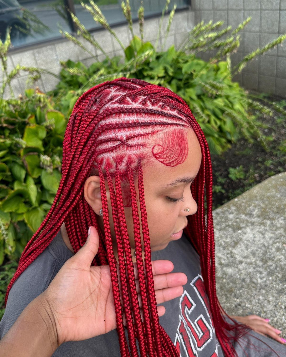 Red Fulani braids with curved scalp cornrows and long braids hanging loose