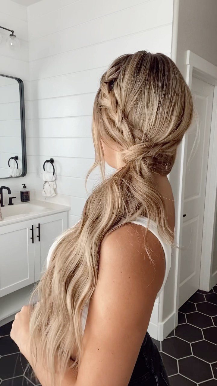 Long blonde side ponytail with a French braid across the back