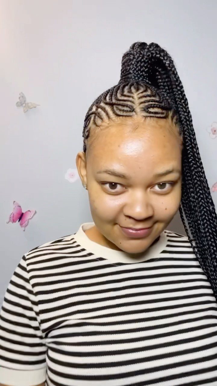 Woman displaying sculptural braided crown patterns gathered into a long high ponytail