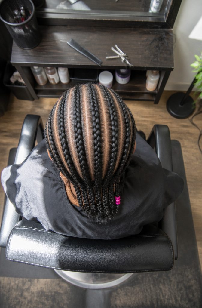 Continuous raised cornrows running closely along the scalp